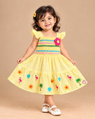 Girls smocked tropical frock with frill sleeves, flower applique, and embroidered flared hem.