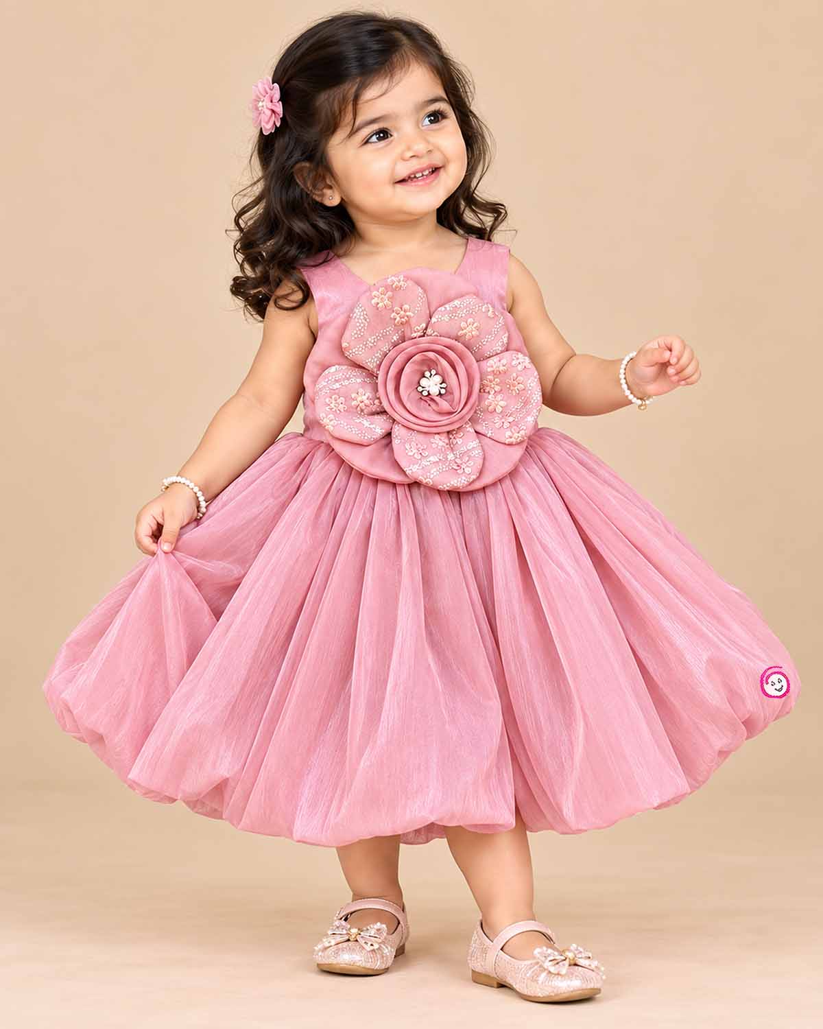 Dusty rose pink toddler net party frock featuring a large floral applique and sleeveless design for girls.