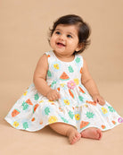 Sleeveless fruit print tiered cotton frock for girls featuring floral waist appliqué and flared A-line silhouette.