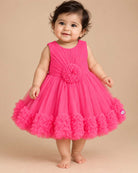 Sleeveless pleated tulle frock for girls with flower applique and ruffled hemline on hanger