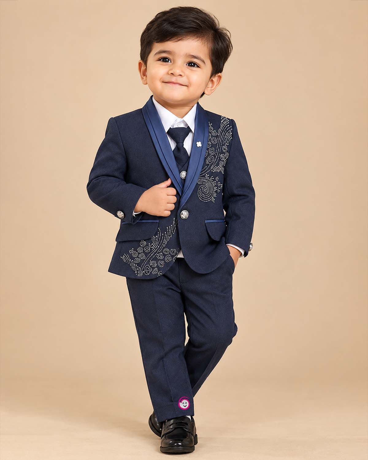 Navy blue formal tuxedo suit set for boys with crystal embellishments, shawl collar jacket, white shirt, tie, and pant for wedding party