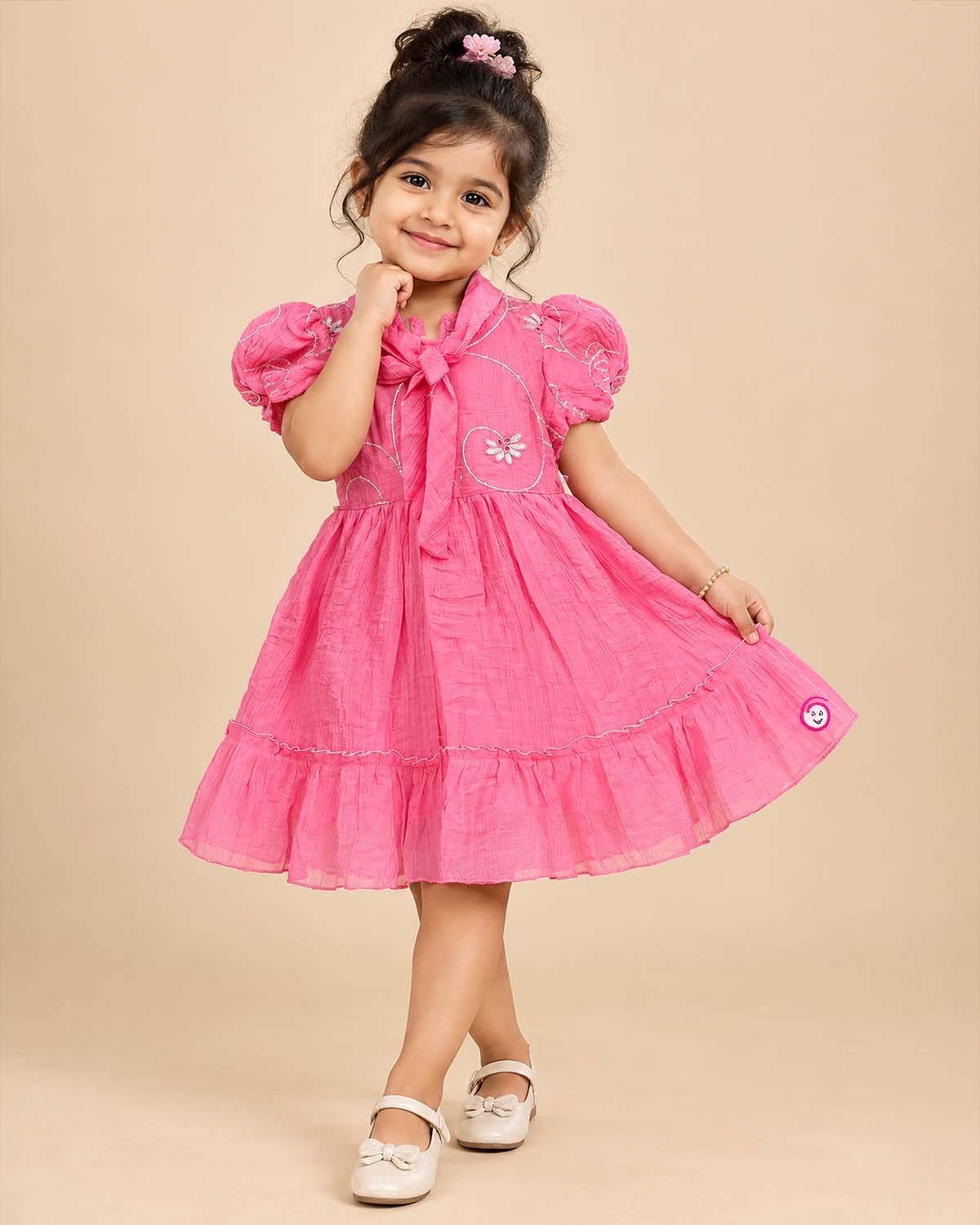 Pink georgette frock with white embroidery and puff sleeves for baby girls