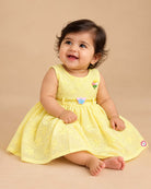 Infants frock with floral schiffli embroidery and butterfly accent for casual wear