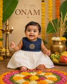 Traditional festive frock for baby girls featuring a sleeveless yoke with golden embroidery and a shimmering tissue skirt, perfect for Onam celebrations.
