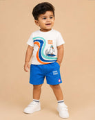 White graphic t-shirt with High Tides surfing seagull print and royal blue elasticated shorts baby boy top and shorts set for summer vacations, playdates, and park outings