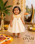 Sleeveless festive ethnic frock for toddler girls featuring a scalloped Peter Pan collar and small floral bodice detail.
